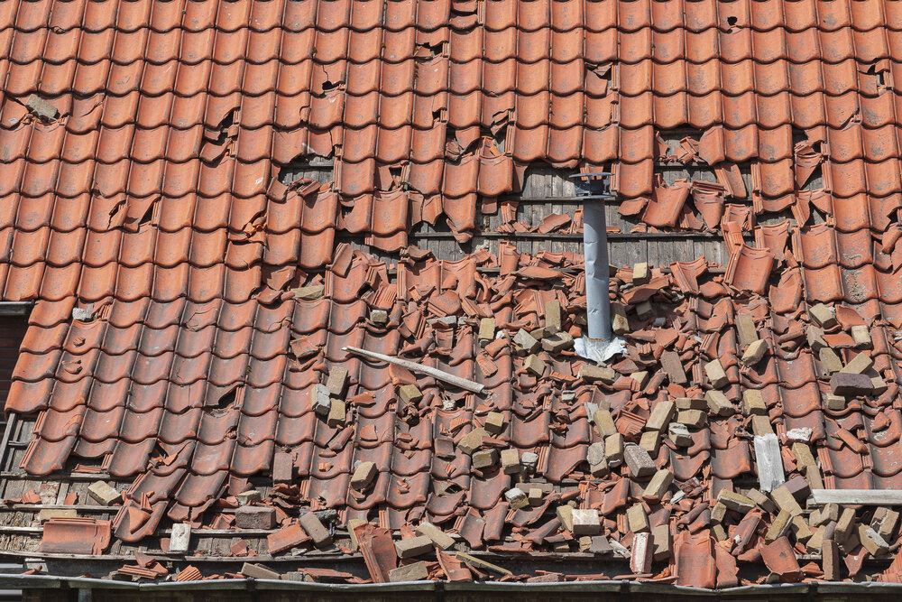storm damage to a tiled roof, destroyed roof tiles, Ceramic roof tiles