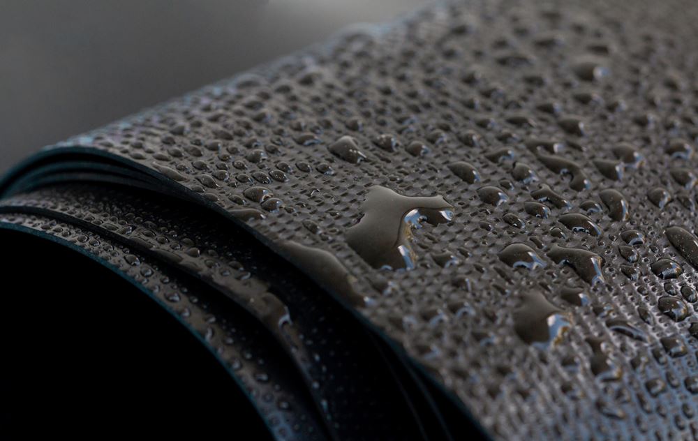 Water droplets on the rubber membrane. Waterproofing... Close-up