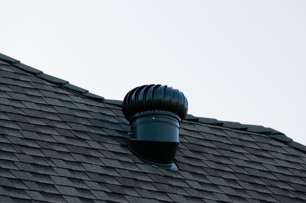 Exhaust roof vent on top of a house, used as a concept for roof vent leaking.